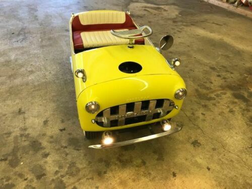 The restored 1950s kids car has real headlights.