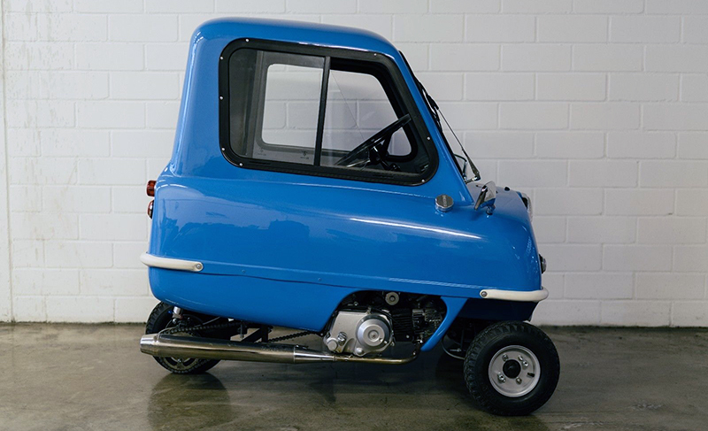 A side-view of a blue Peel P50