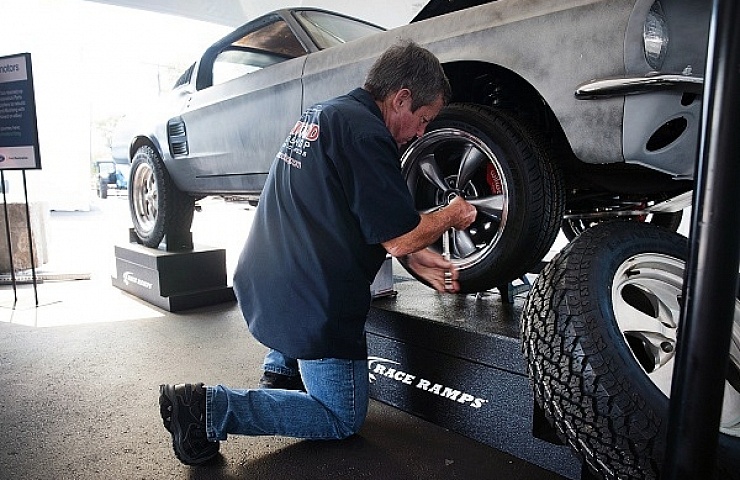 Randy Allgood bolts on an alternate wheel selection for the eBay Motors 1967 Ford Mustang Fastback.