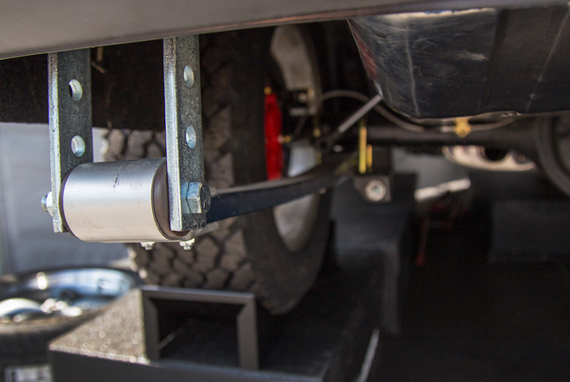 The temporary rear leaf-spring shackles will be removed after the final suspension components are installed.