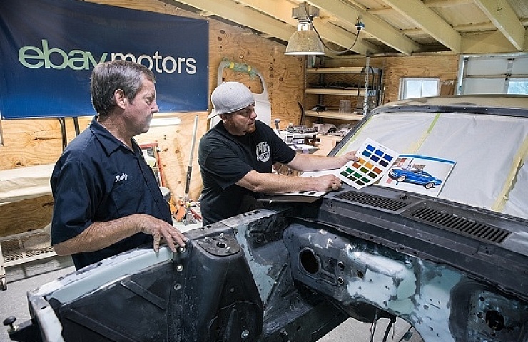 Randy Allgood and K.C. Mathieu comb through the BASF color charts in search of the optimal color combination.