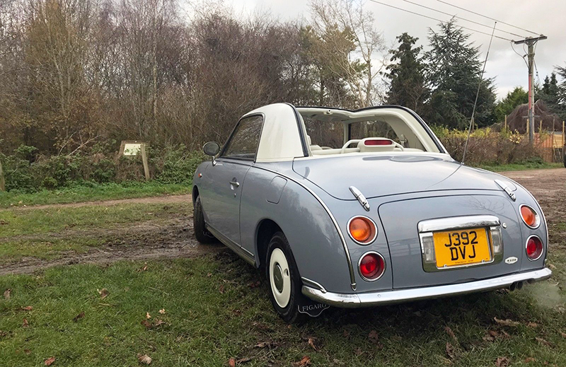 The British car showing off its fold-down top.