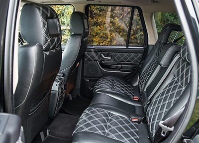 The rear seats feature headrest-mounted screens.