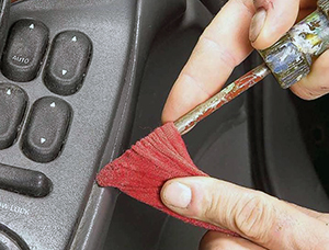 A flathead screwdriver and a moist rag gets the gunk out of the grooves in your interior. This car cleaning hack requires zero investment.