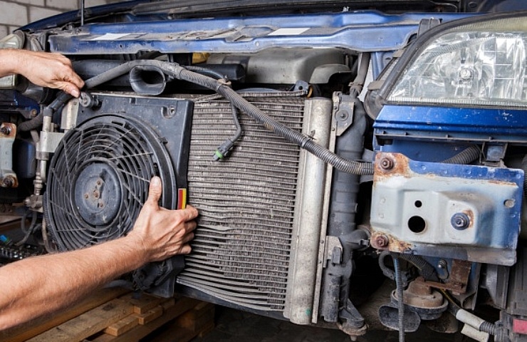 Removing an old radiator fan and radiator.