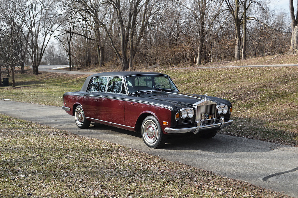 Two-tone burgundy and black paint suit the car, which received a $30,000 bare-metal repaint. Note the period viny roof.