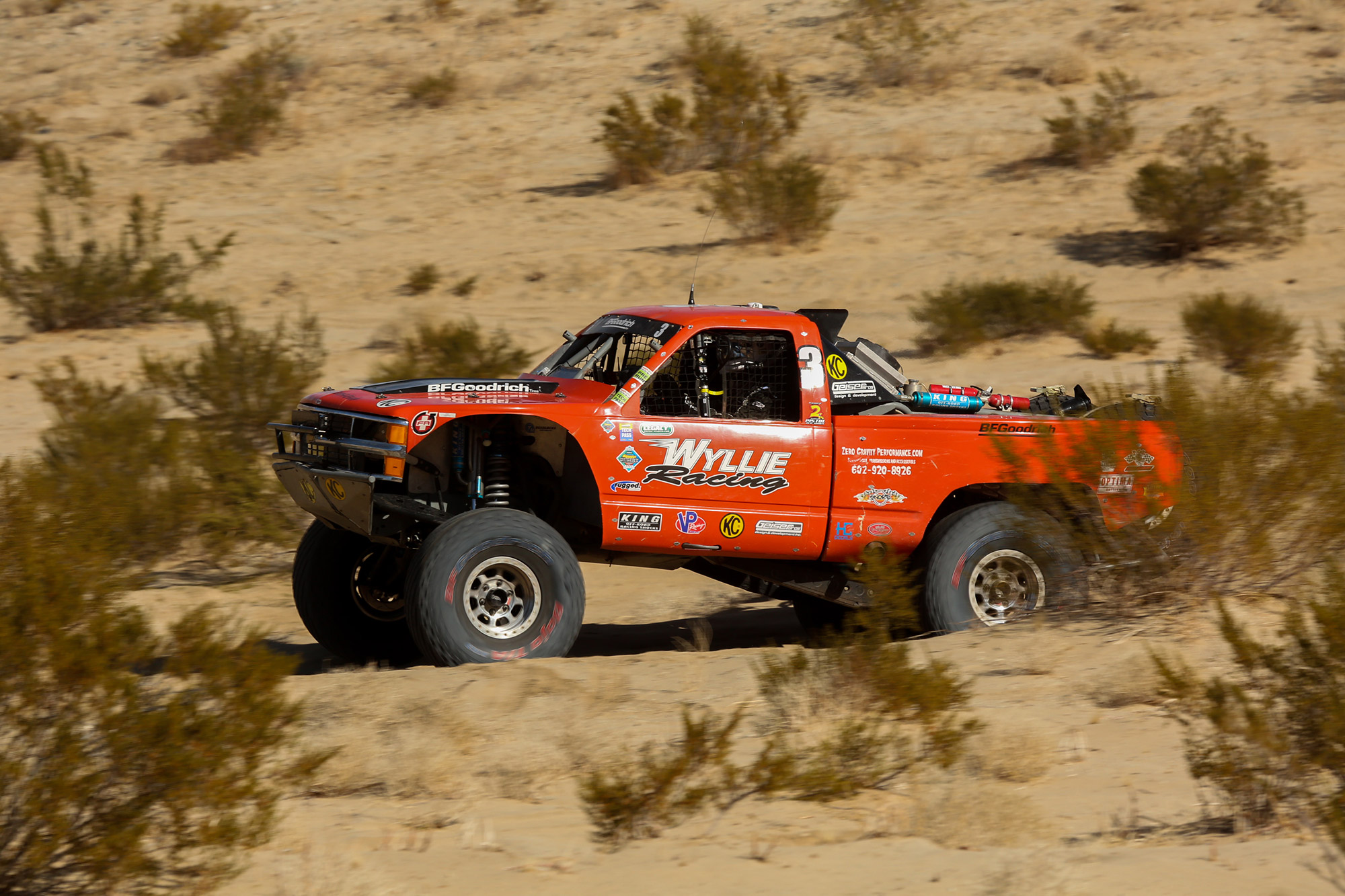 Wylie racing putting the pedal down after jumping his OBS Chevy Silverado in the desert portion of the race.