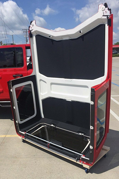 A cart offers a safe storage solution for the Jeep hardtop.