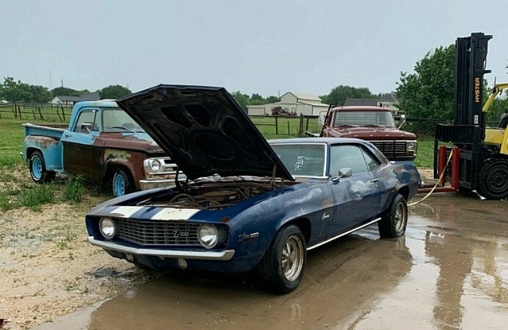 Spraying off the barn find Camaro's decades of grime.