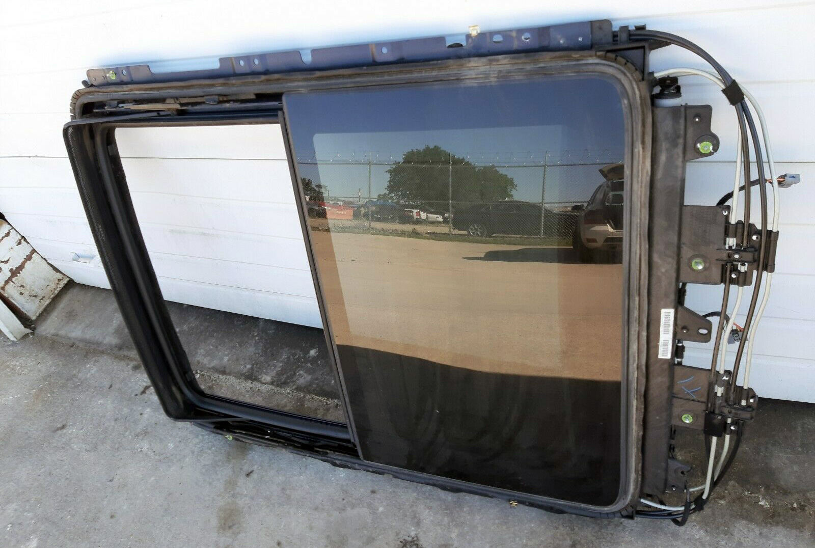 This panoramic roof track (with rear glass intact) fits the 2010 to 2016 Cadillac SRX.