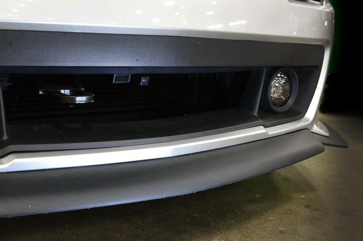 A mounted camera or sensor to help with parking is barely noticeable