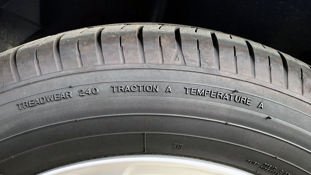Tire markings for treadwear, traction, and temperature standards