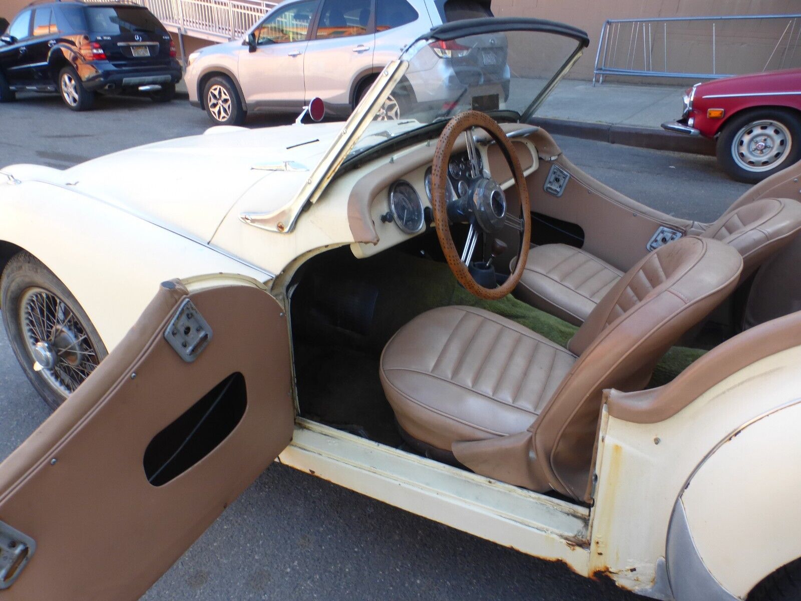 Ivory 1958 Triumph TR3 with light brown interior seating