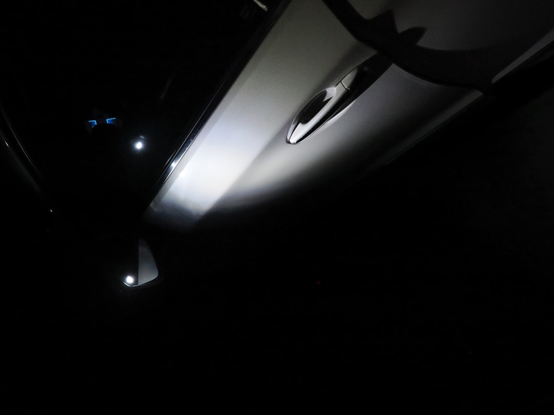 Light from a car puddle light viewed from below the side mirror.