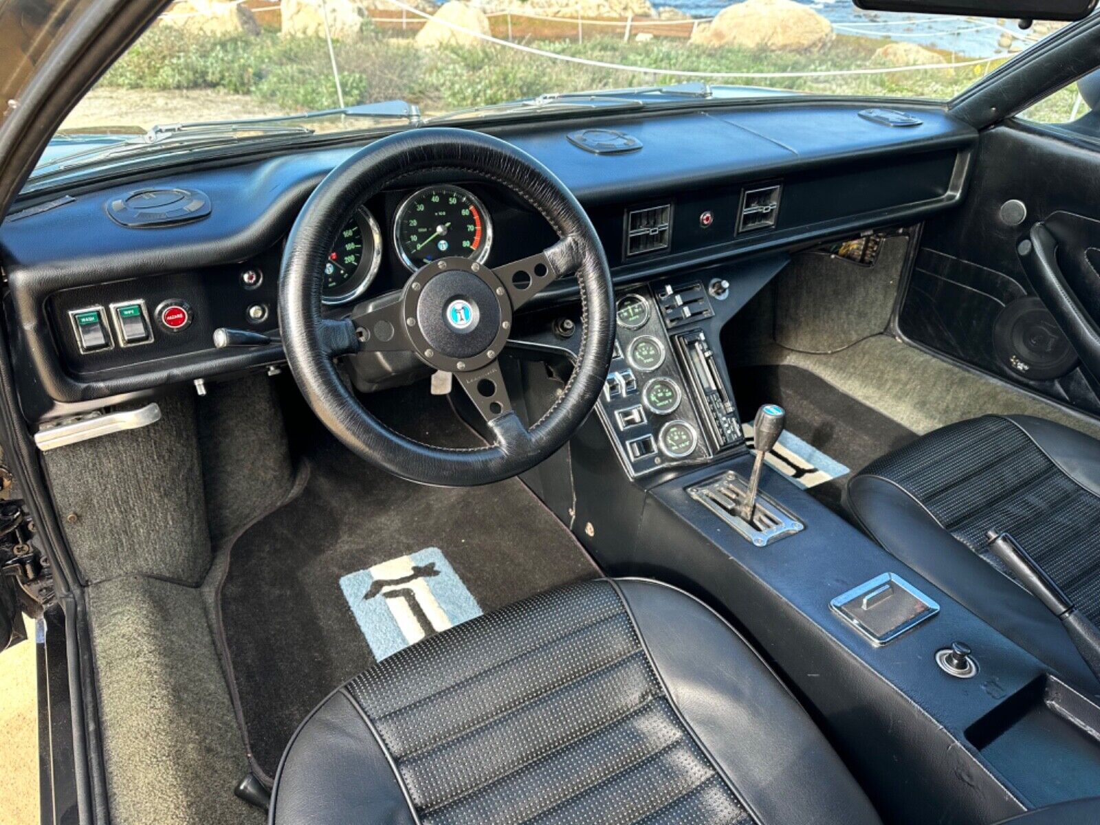 1974 De Tomaso Pantera interior from driver's side, with steering wheel, dashboard and center console