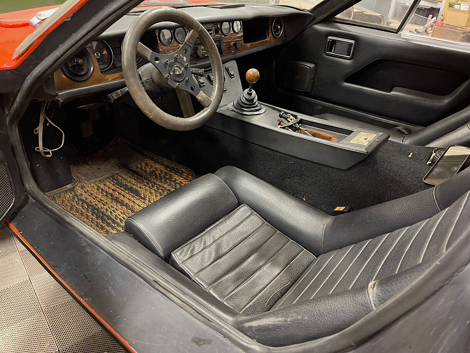 1973 Lotus Europa - left side interior view - drivers seat, shifter and steering wheel