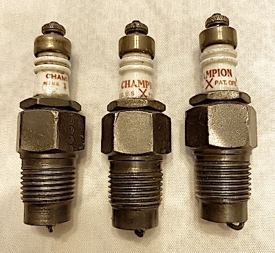 three vintage Champion spark plugs
