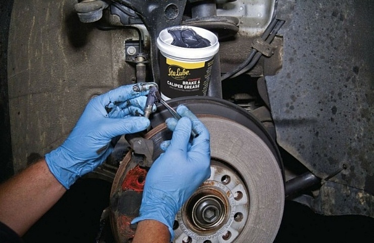 Mechanic greasing brakes with Sta-Lube