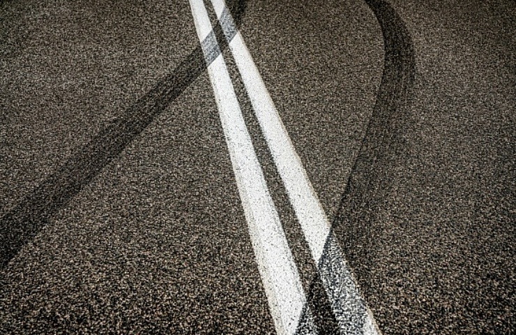 Tire skid marks crossing double lines