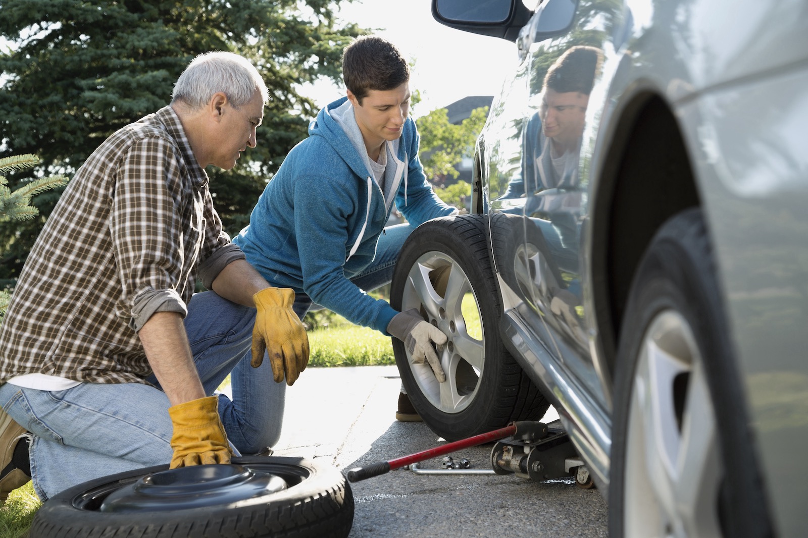 Father and son changing a tire