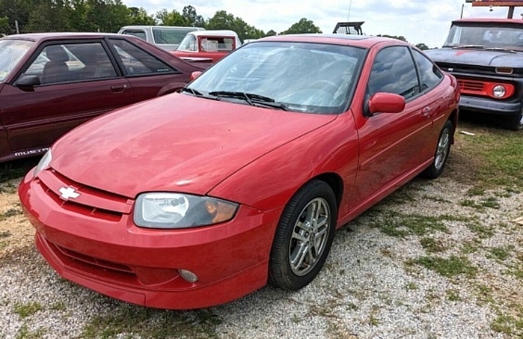 Red Chevy coupe with condensation in headlights