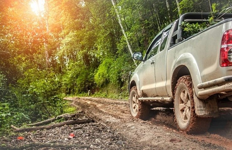 Pickup truck driving on muddy trail