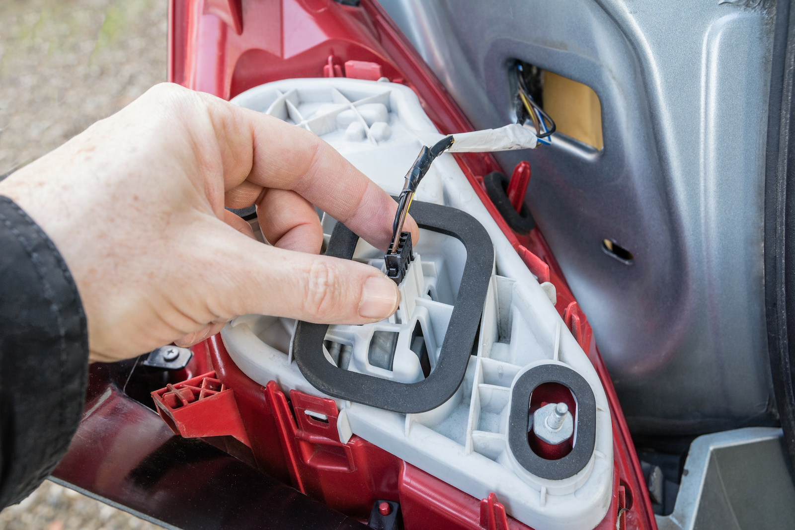 Replacing a bulb in a tail light assembly