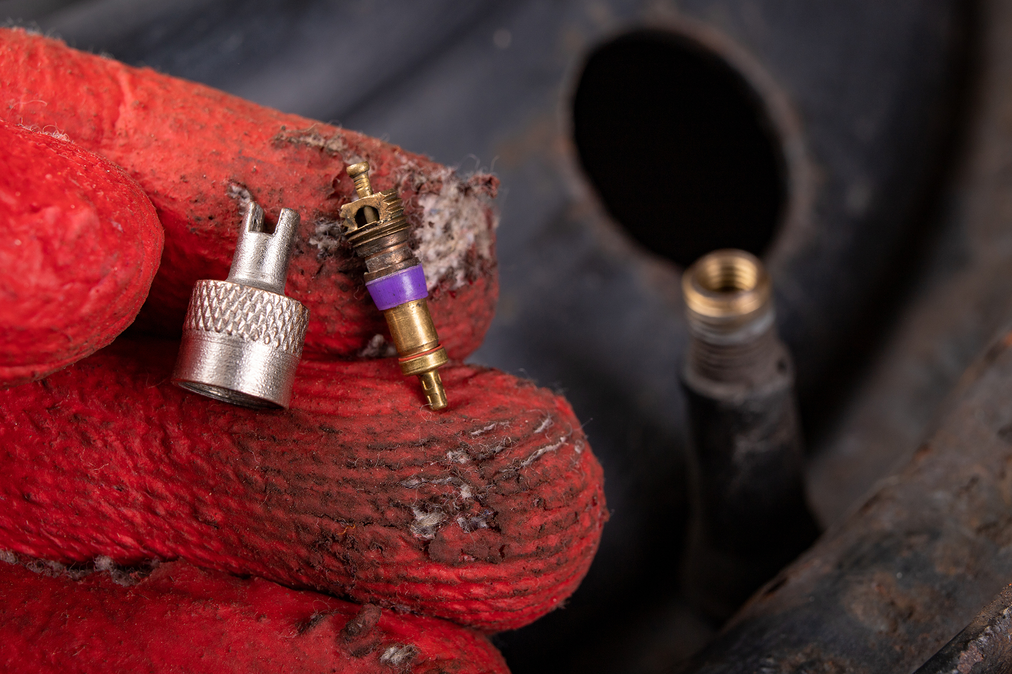 Close-up shot of a broken tire valve stem being repaired