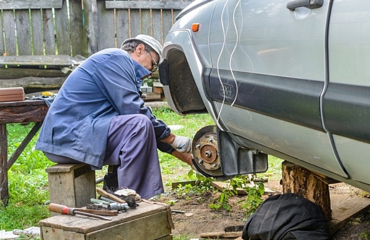 Senior mechanic works on brakes