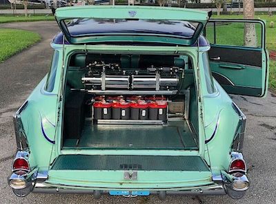 Open trunk showing hydraulics and batteries