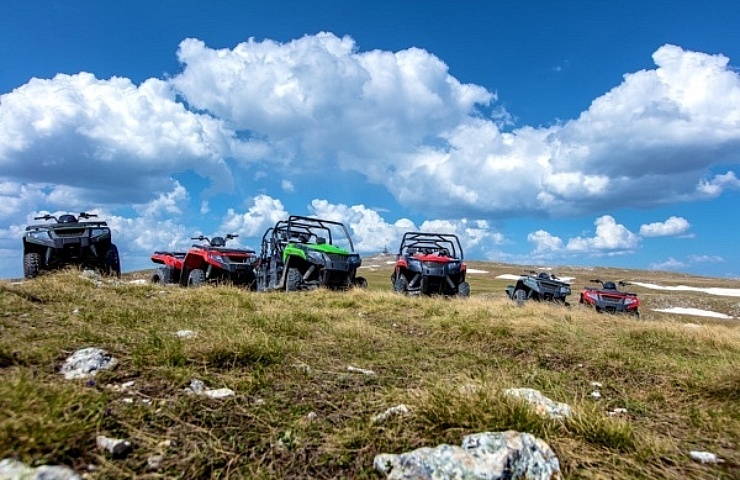 ATVs and UTVs parked on mountain peak
