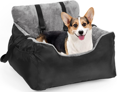 A small terrier in a dog car seat