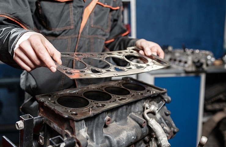 A mechanic disassembles an engine block