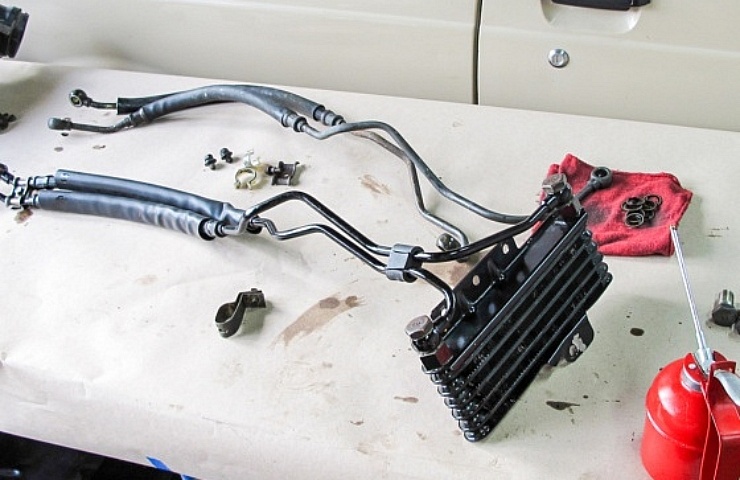 A car engine oil cooler and lines on a table