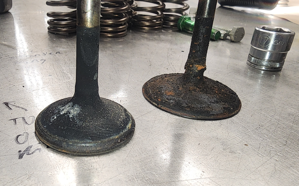 An car engine exhaust and intake valve with excessive carbon build up