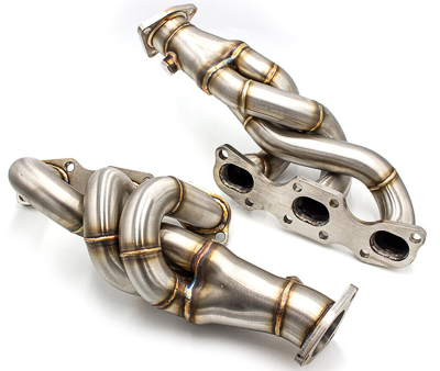 A pair of aftermarket performance exhaust headers for a Nissan V-6 engine