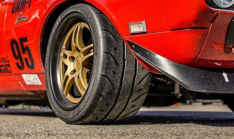 A low angle view of a Falken Azenis RT660 ultra high performance tire on a Chevrolet Camaro.
