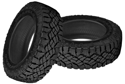 A pair of dismounted Goodyear Wrangler Duratrac off-road tires.