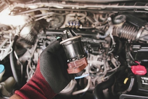 Mechanic holding an EGR valve