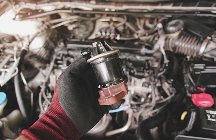 Mechanic holding an EGR valve