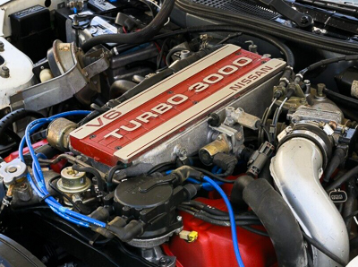 An under the hood photo of a turbocharged Nissan 3.0-liter V-6 engine