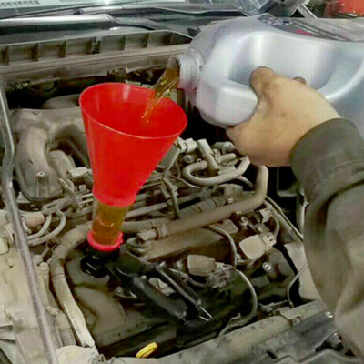 Adding motor oil into an engine through a funnel