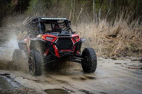 UTV/4x4 driving through muddy puddle