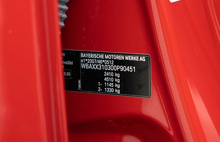 A VIN tag for a red BMW