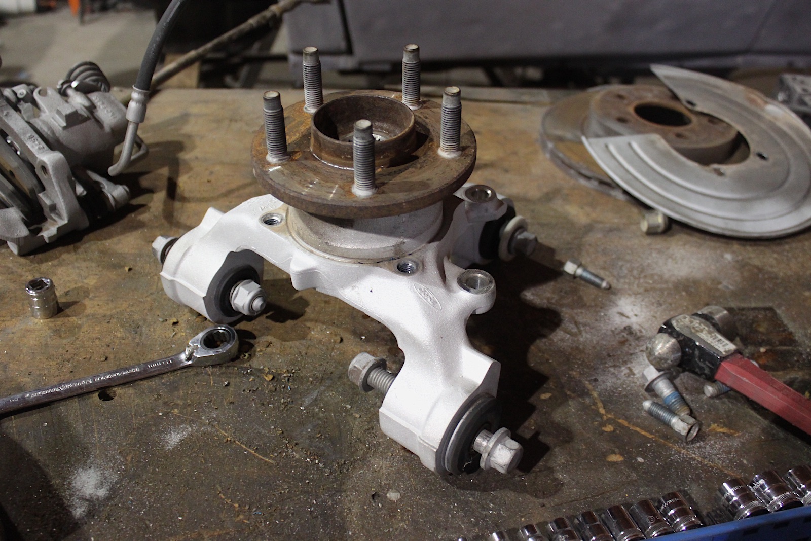 FWD, AWD, and IRS RWD vehicles use hubs like this mid-1990s Ford Thunderbird hub. The rotating hub (with the wheel lug studs) has a replaceable roller bearing. Many modern vehicles require replacing the entire hub or knuckle.