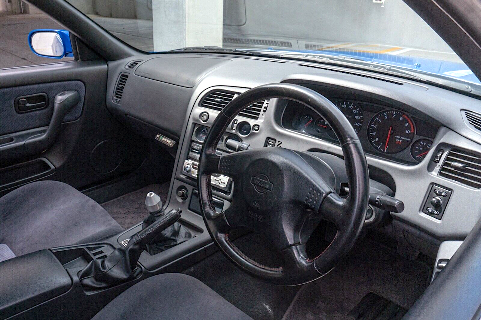 1996 Nissan GT-R R33 LM Skyline - interior, driver's side - steering wheel, shifter, dashboard