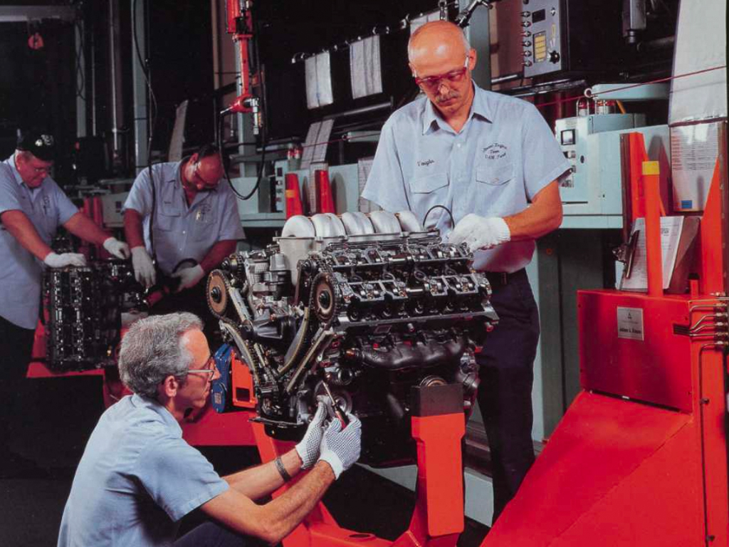A team of techniciand building a Ford SVT Mustang V-8 on an assembly line