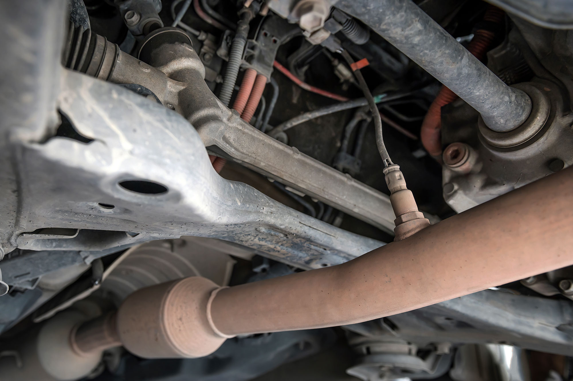 The oxygen or 02 sensor, shown at right, mounts into a threaded bung welded into the exhaust pipe.