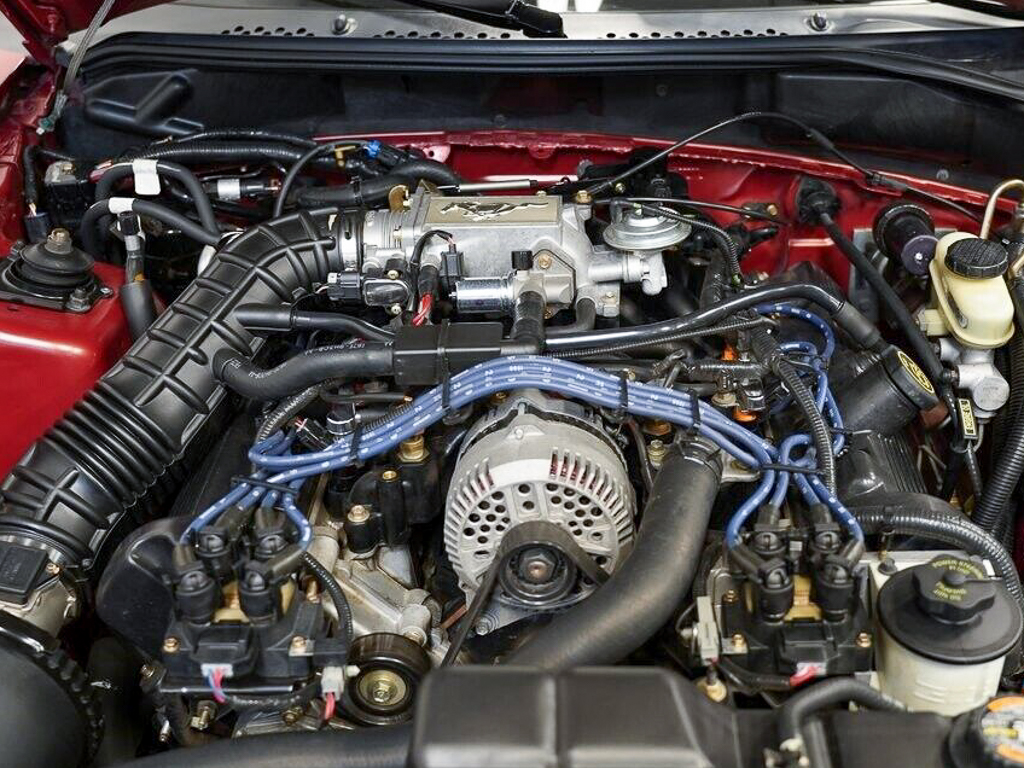 Looking down into the engine bay of a 1998 Ford Mustang
