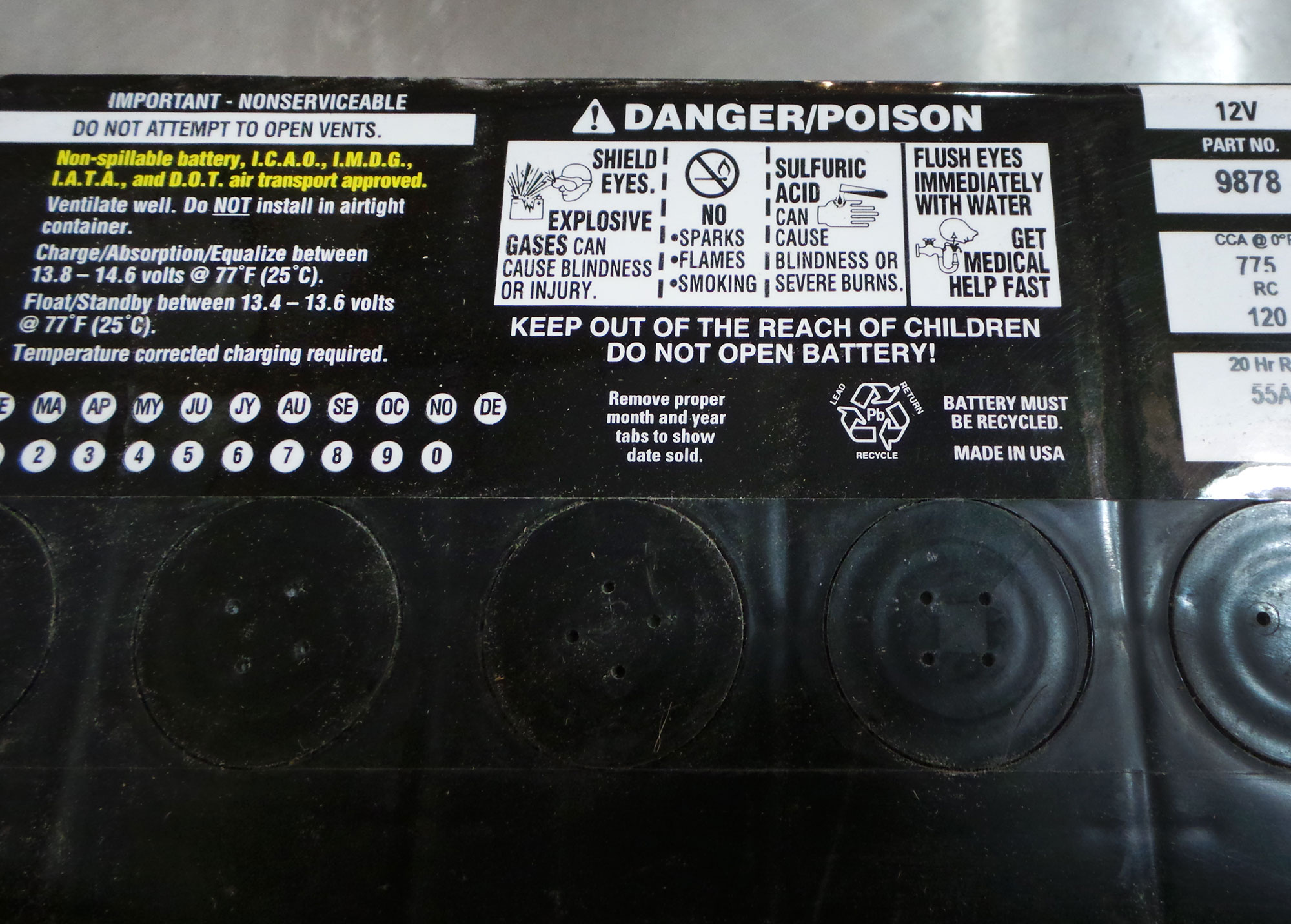 Warnings about toxicity on the top of a car battery